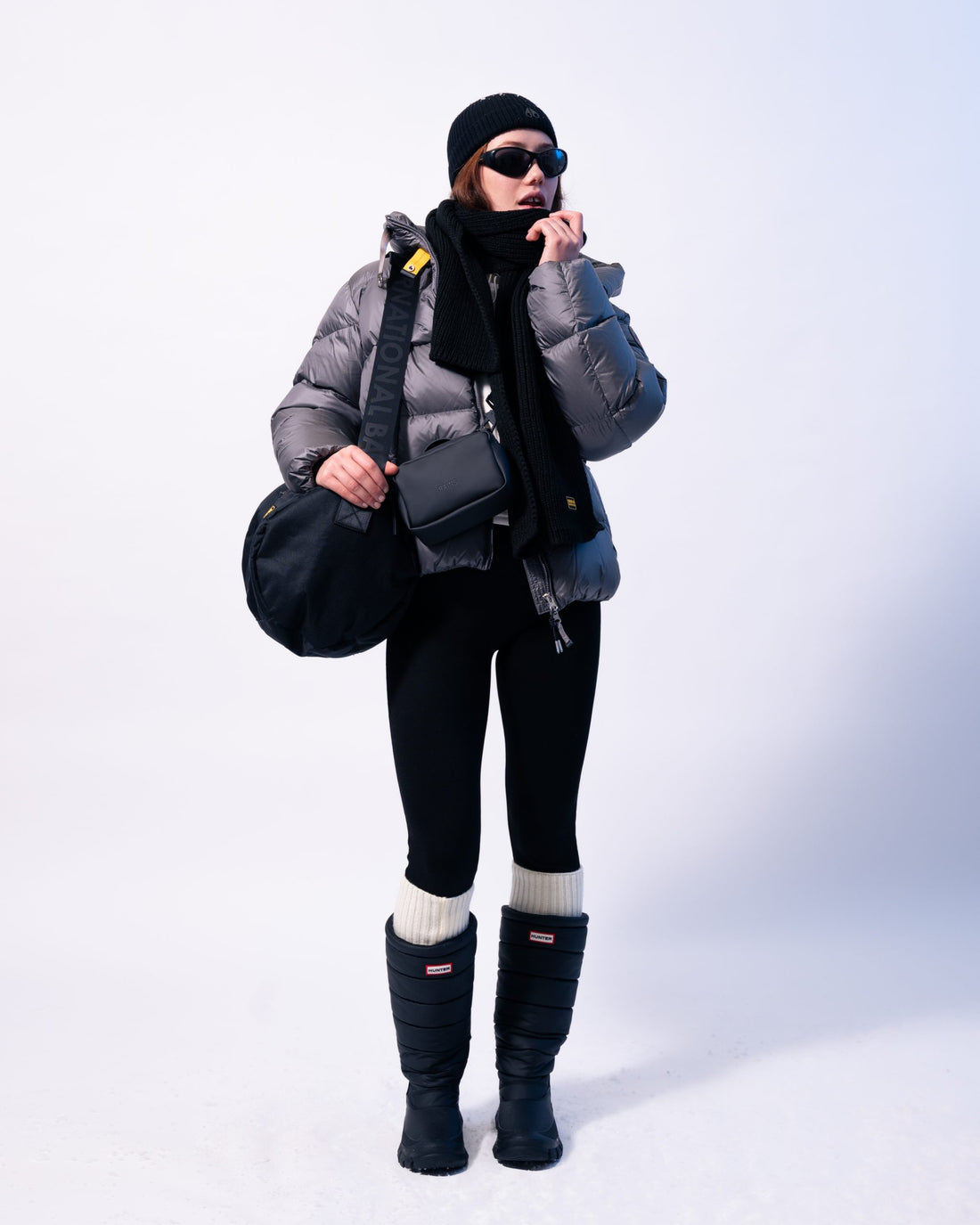 women dress in a puffer jacket, legging and wellingtons ready for the snow