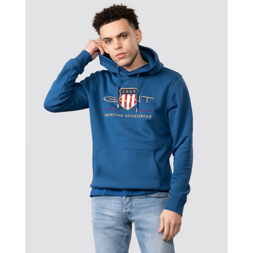 man wears GANT original hoody with bold crest