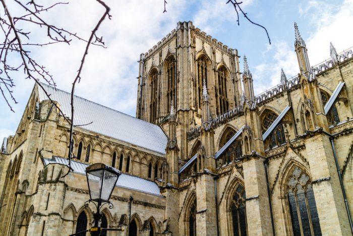 An upwards shot of York Minster covered in snow