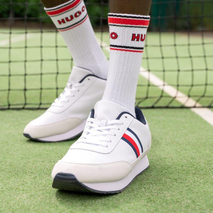 A close up of a man's Tommy Hilfiger trainers and white crew length HUGO socks