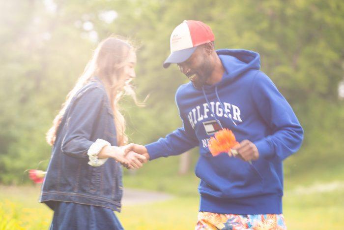 Man and women dance in a festival field