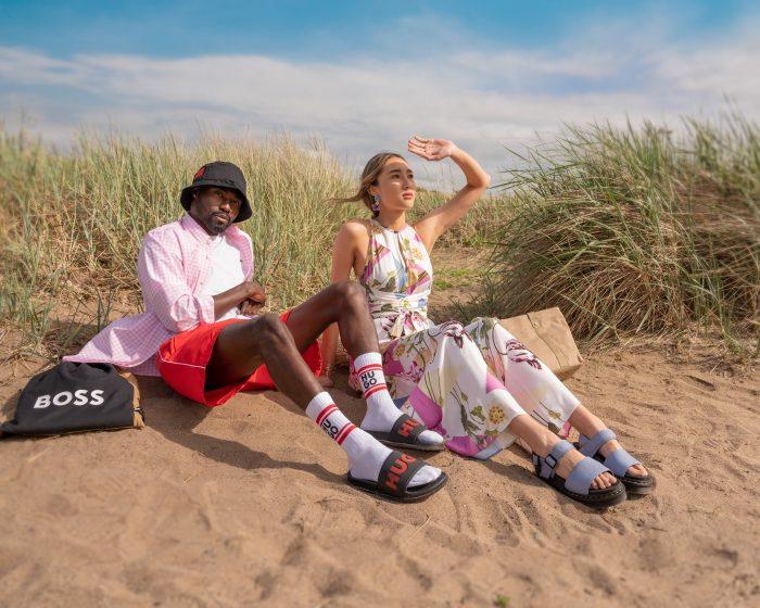 Man and woman soak up the sun on the beach