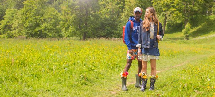 Wide shot of man and woman posing in a festival field