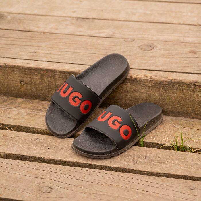 A close up of some black and red Hugo sliders positioned on some decking