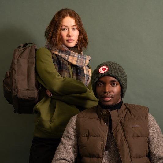 A man and woman wear stylish, neutral country clothing