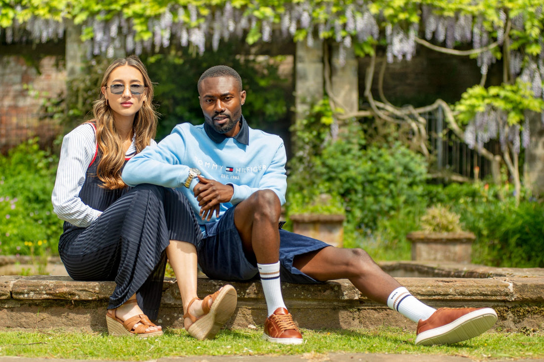woman and man sat in the garden dresses in classic style fashion