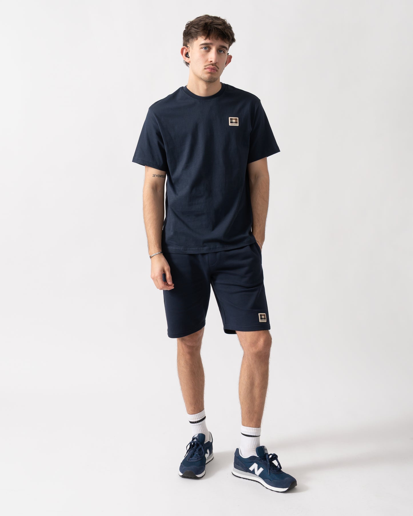 full length shot of a model wearing an Aquascutum Mens Badge T-Shirt in Navy 11