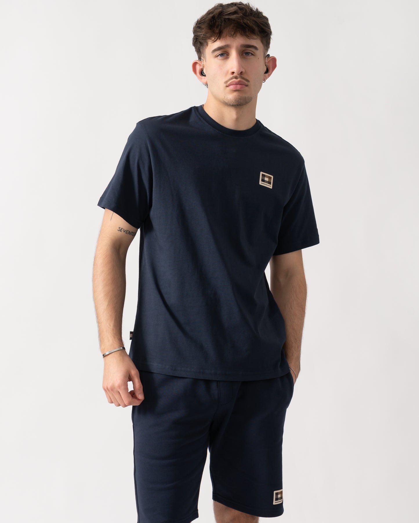 Studio shot of a model wearing an Aquascutum Mens Badge T-Shirt in Navy 11