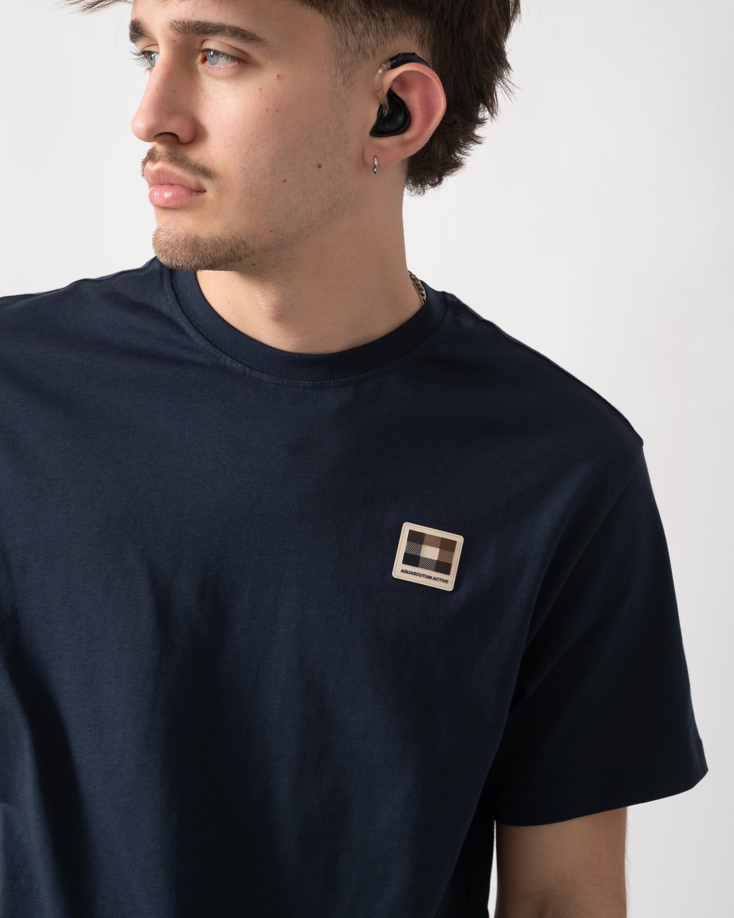 close up shot of a model wearing an Aquascutum Mens Badge T-Shirt in Navy 11