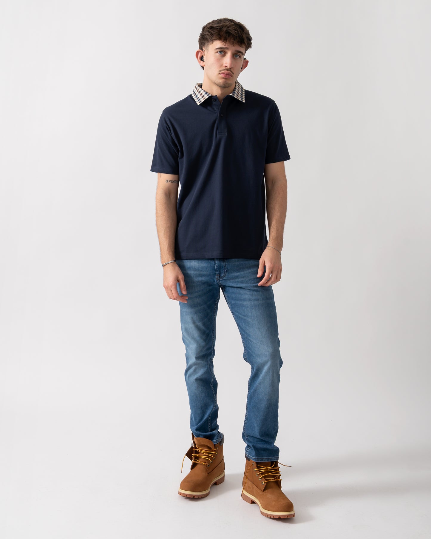 full length shot of a model wearing an Aquascutum Mens Club Check Collar Polo Shirt in Navy 11