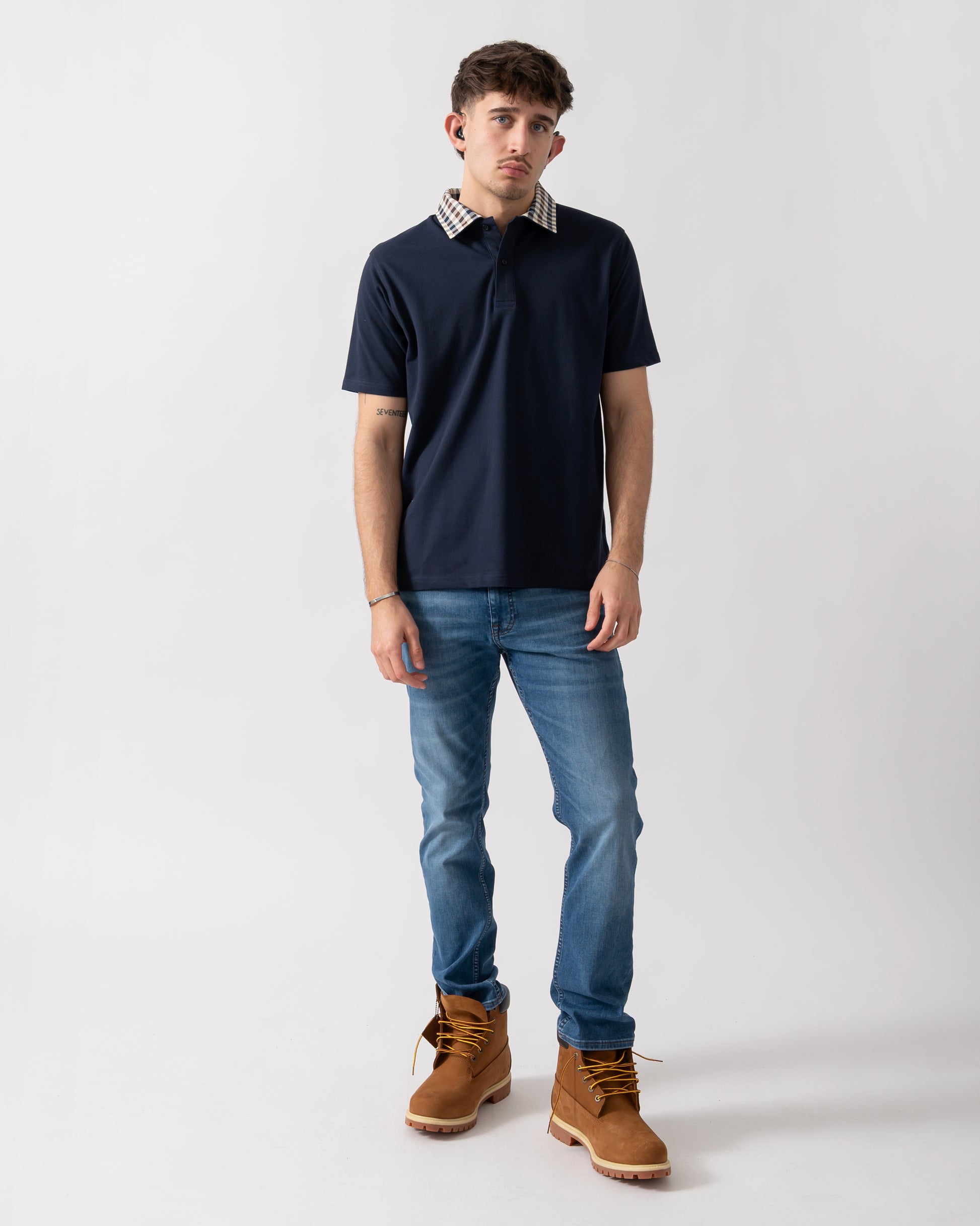 full length shot of a model wearing an Aquascutum Mens Club Check Collar Polo Shirt in Navy 11