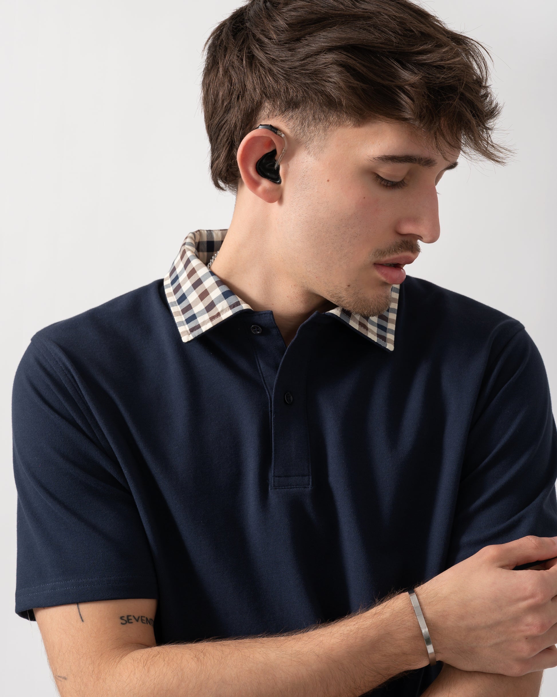 close up shot of a model wearing an Aquascutum Mens Club Check Collar Polo Shirt in Navy 11