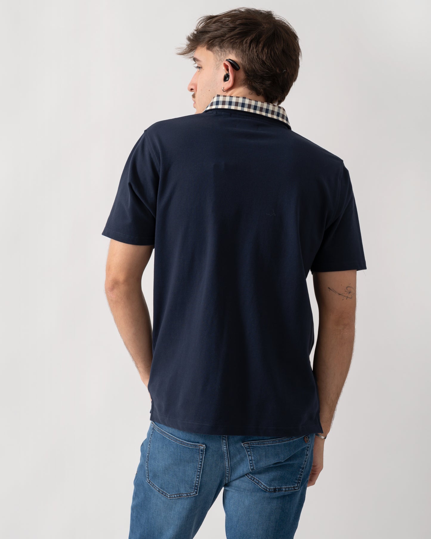 back shot of a model wearing an Aquascutum Mens Club Check Collar Polo Shirt in Navy 11