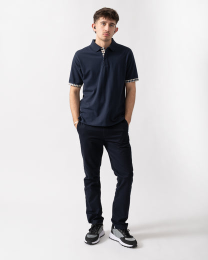 full length shot of a model wearing an Aquascutum Mens Club Check Stretch Piquet Sleeves Polo Shirt in Navy 11