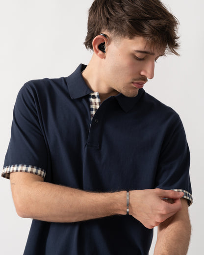 close up shot of a model wearing an Aquascutum Mens Club Check Stretch Piquet Sleeves Polo Shirt in Navy 11