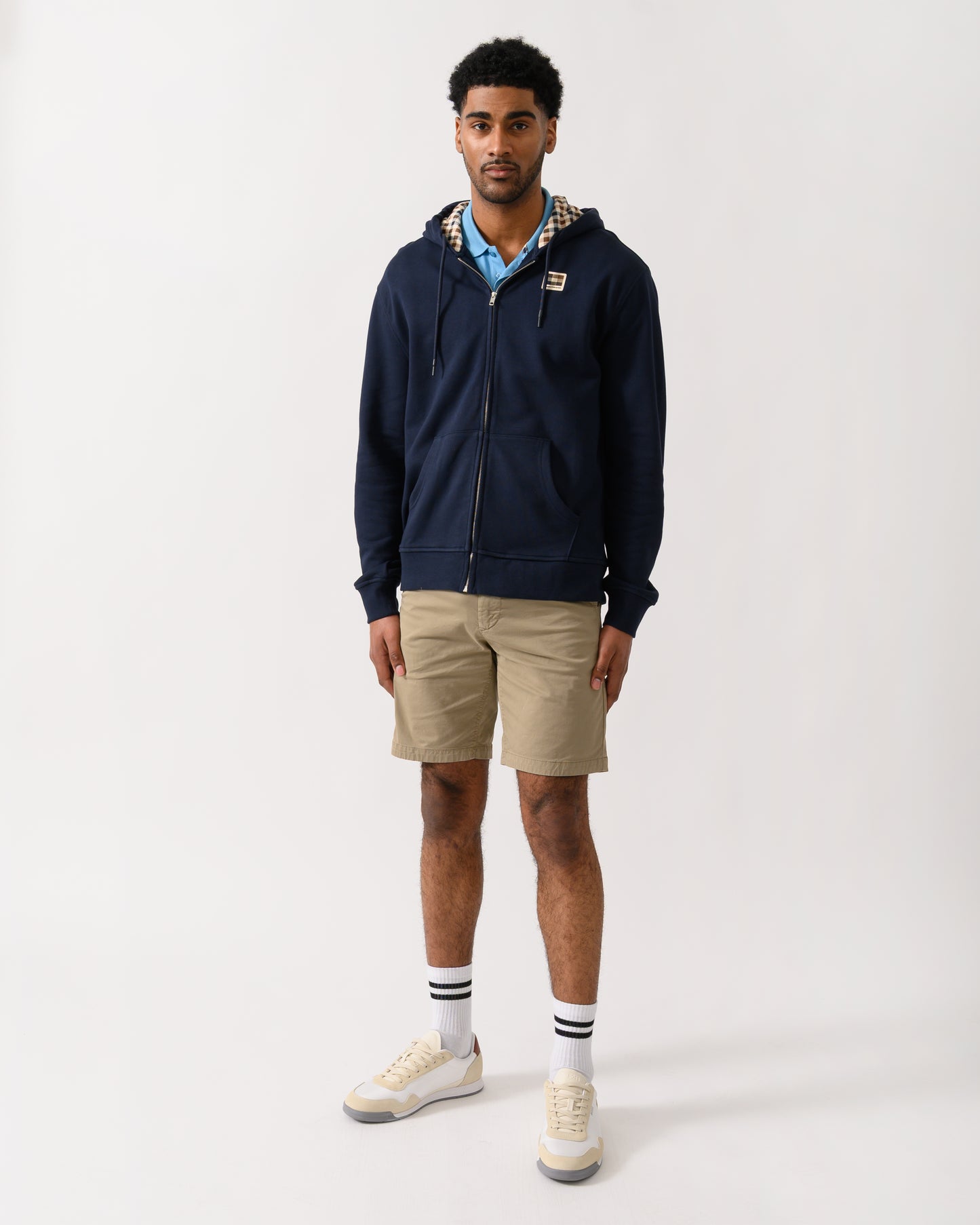 full length shot of a model wearing an Aquascutum Mens Full Zip Badge Hoodie in Navy