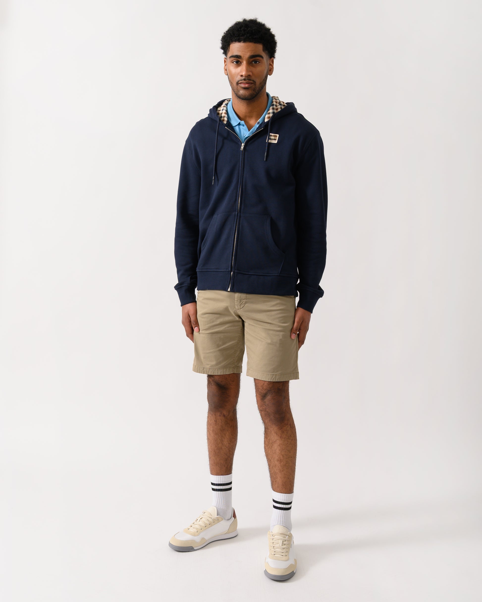 full length shot of a model wearing an Aquascutum Mens Full Zip Badge Hoodie in Navy