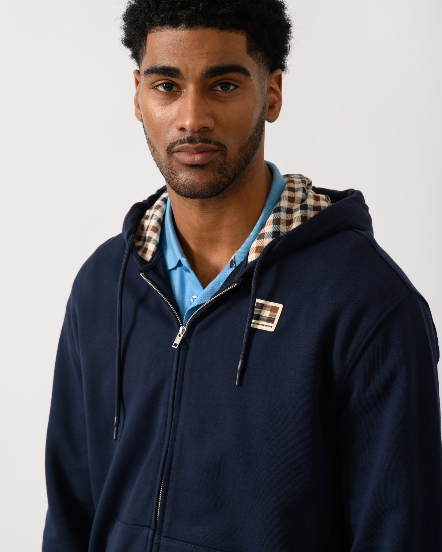 detail view of a model wearing an Aquascutum Mens Full Zip Badge Hoodie in Navy