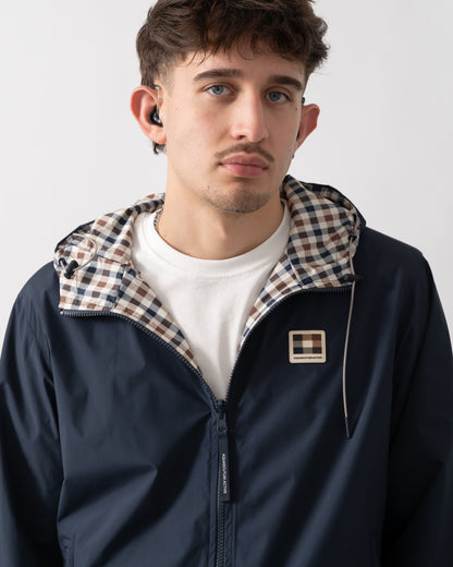 close up studio shot of a model wearing an Aquascutum Mens RLG Badge Reversible Sailor Jacket in Navy 11