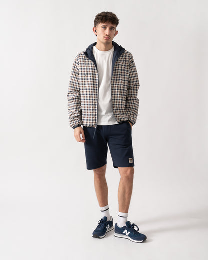 full length shot of a model wearing an Aquascutum Mens RLG Badge Reversible Sailor Jacket in Navy 11 showing reversed check pattern