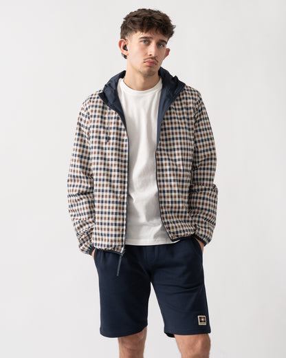 studio shot of a model wearing an Aquascutum Mens RLG Badge Reversible Sailor Jacket in Navy, showing reversed check pattern