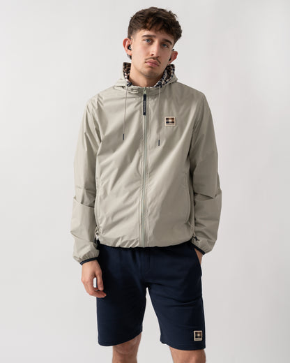 studio shot of a model wearing an Aquascutum Mens RLG Badge Reversible Sailor Jacket in Salvia 34