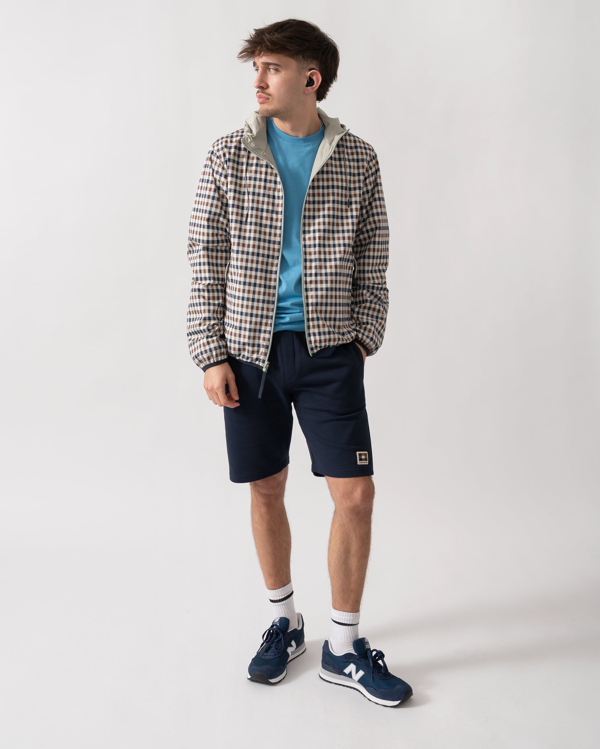 full length shot of a model wearing an Aquascutum Mens RLG Badge Reversible Sailor Jacket in Salvia 34 showing reversed check pattern