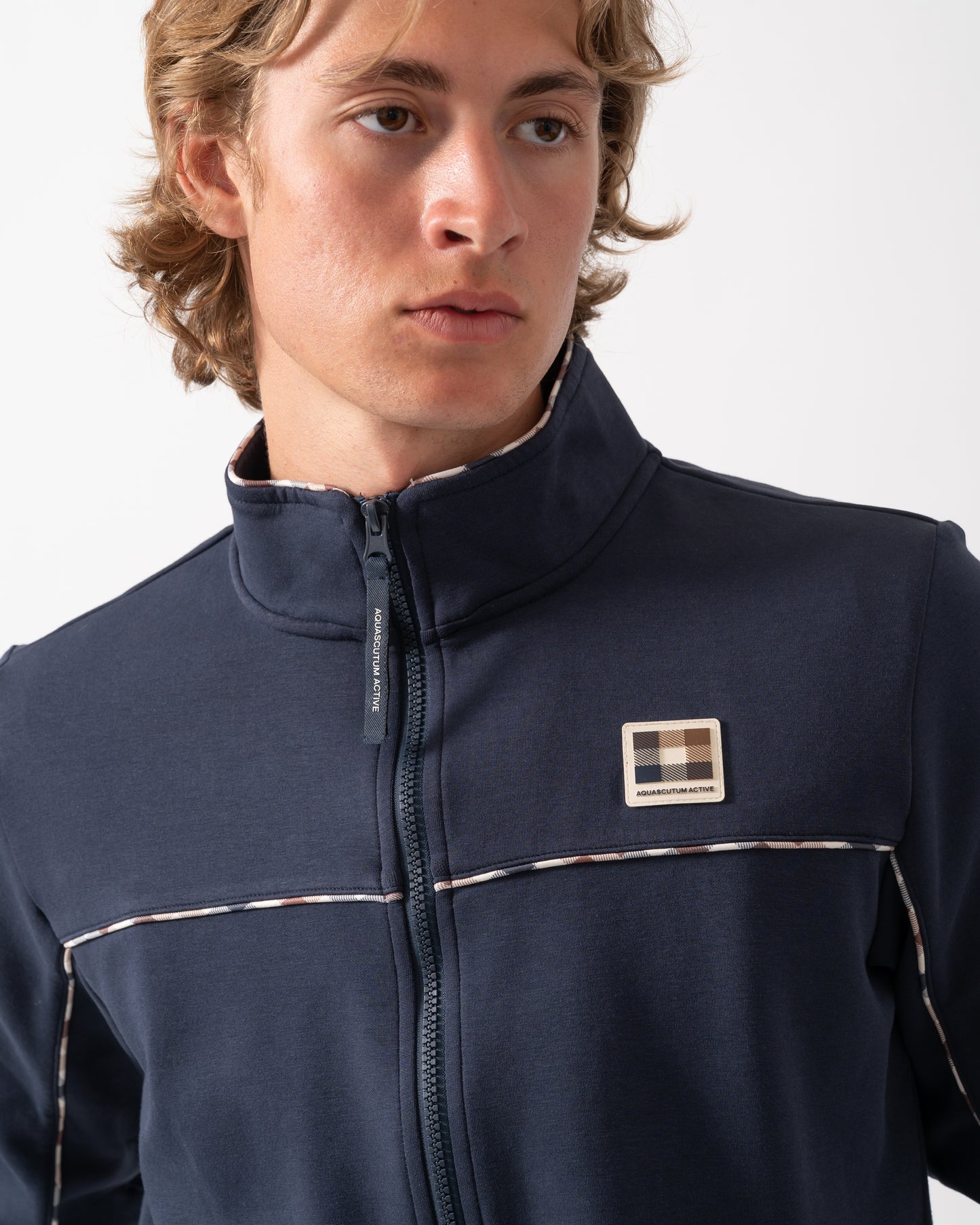 close up shot of a model wearing Aquascutum Mens Scuba Piping Track Top in Navy 11