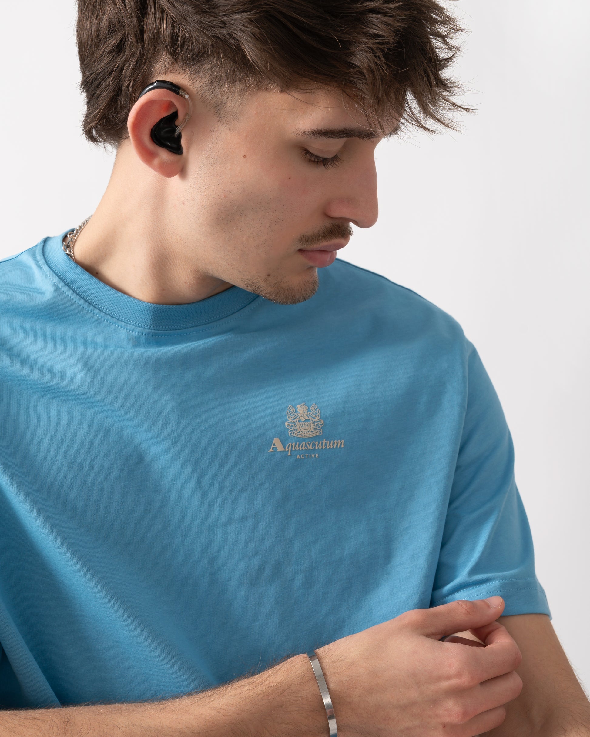 close up shot of a model wearing an Aquascutum Mens Small Logo T-Shirt in Avio 18
