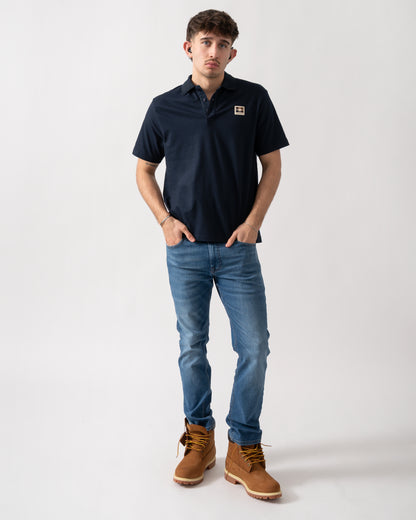 full length shot of a model wearing an Aquascutum Mens Stretch Piquet Badge Polo Shirt in Navy 11