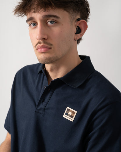 close up shot of a model wearing an Aquascutum Mens Stretch Piquet Badge Polo Shirt in Navy 11