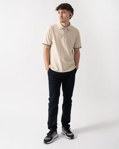 full length shot of a model wearing an Aquascutum Mens Club Check Stretch Piquet Sleeves Polo Shirt in Beige 03