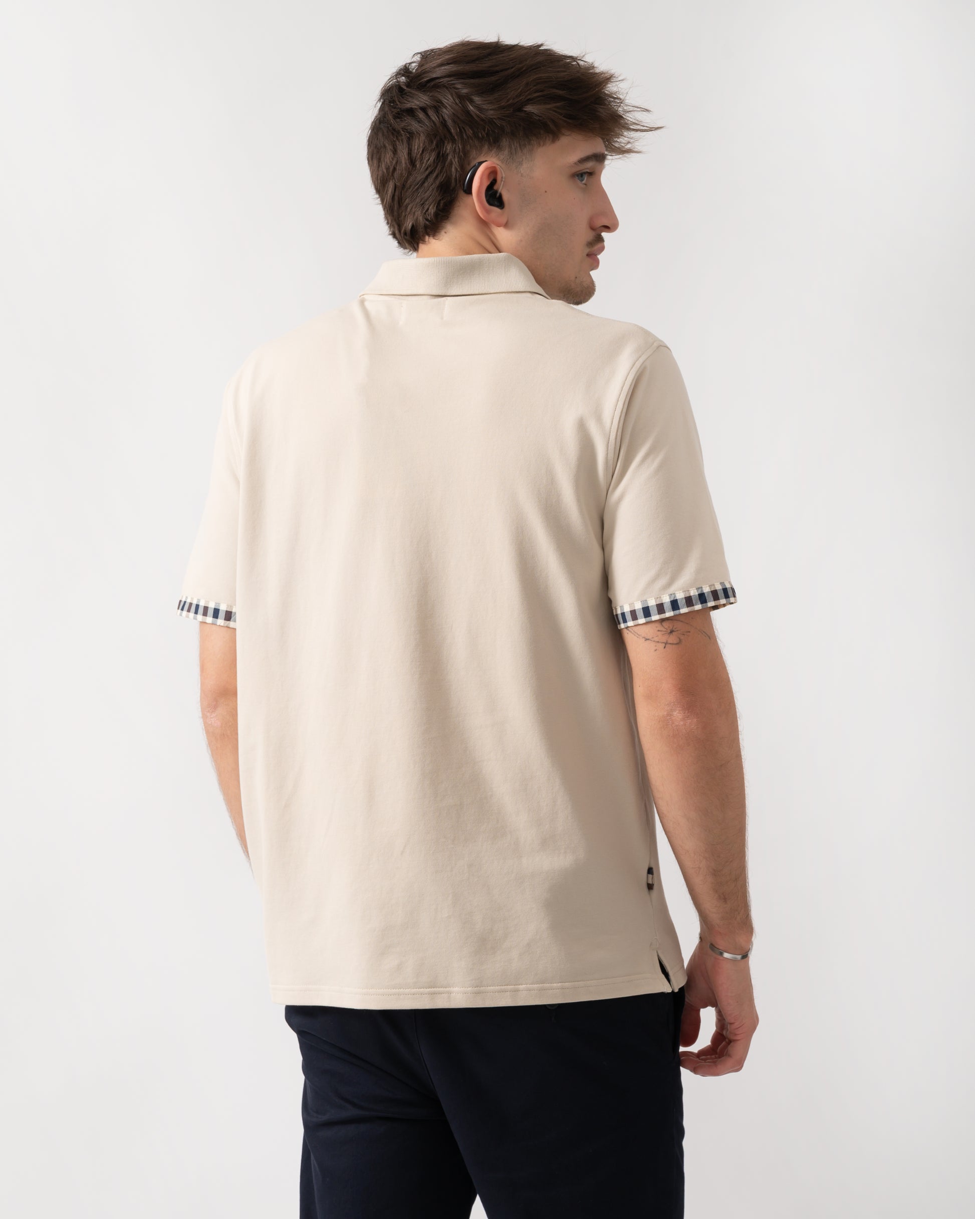 back shot of a model wearing an Aquascutum Mens Club Check Stretch Piquet Sleeves Polo Shirt in Beige 03