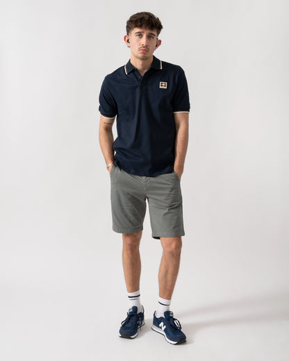 full length shot of a model wearing an Aquascutum Mens Stretch Piquet Tipped Badge Polo Shirt in Navy 11
