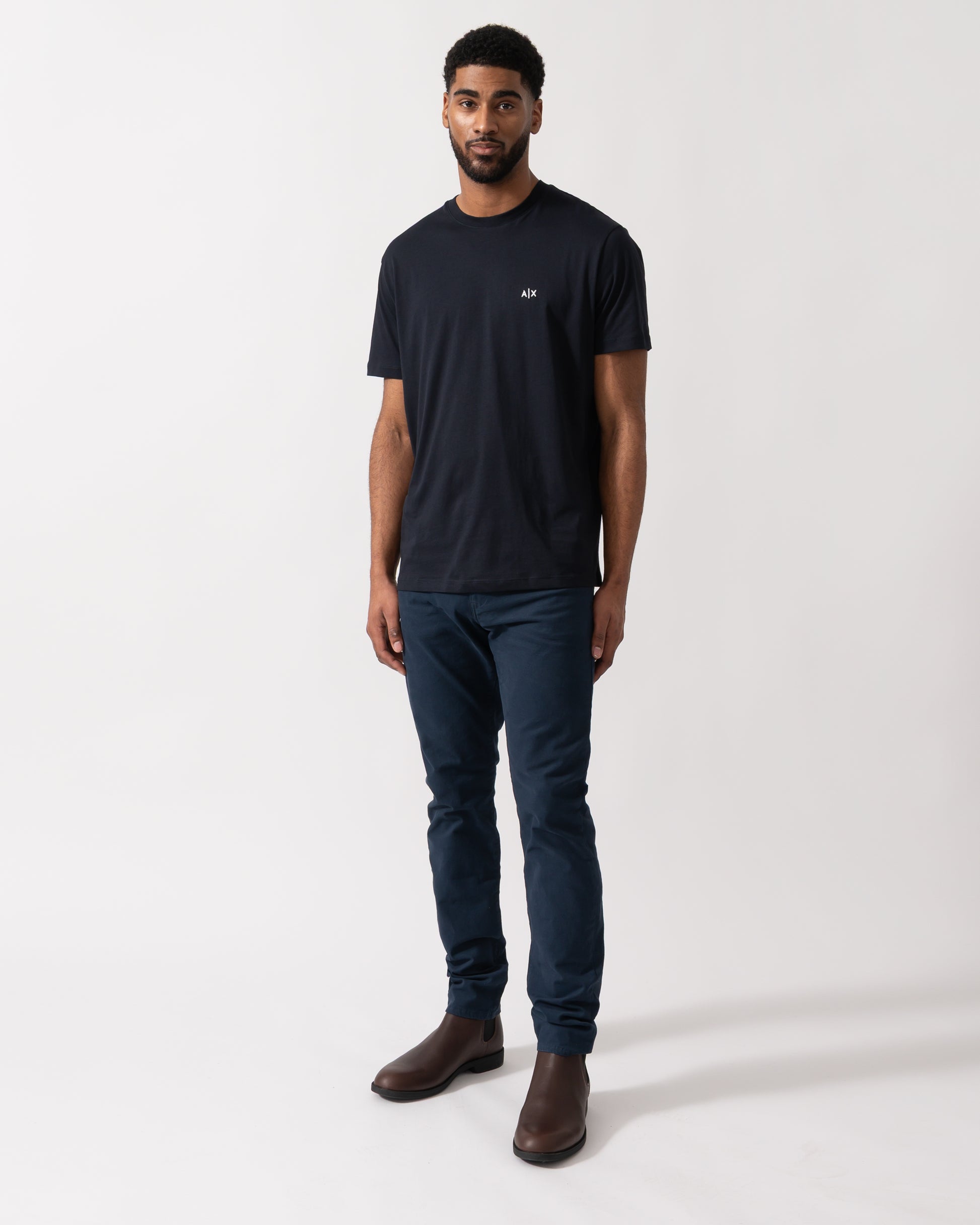 Full length shot of a model wearing an Armani Exchange Mens A|X Monogram T-Shirt in Deep Navy