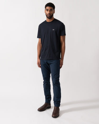 Full length shot of a model wearing an Armani Exchange Mens A|X Monogram T-Shirt in Deep Navy