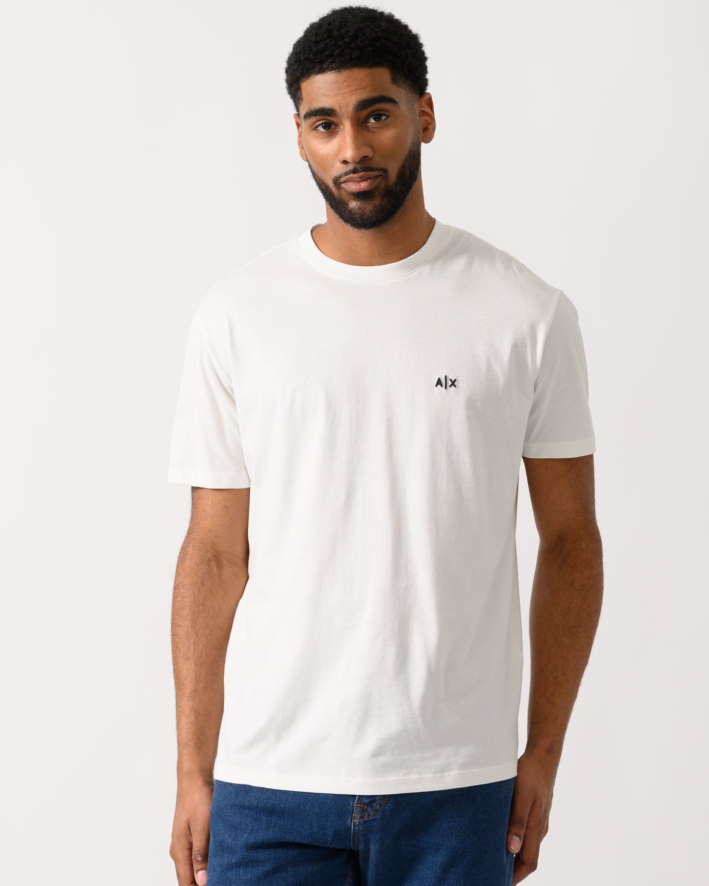 Model wearing a Armani Exchange Mens A|X Monogram T-Shirt in Off White