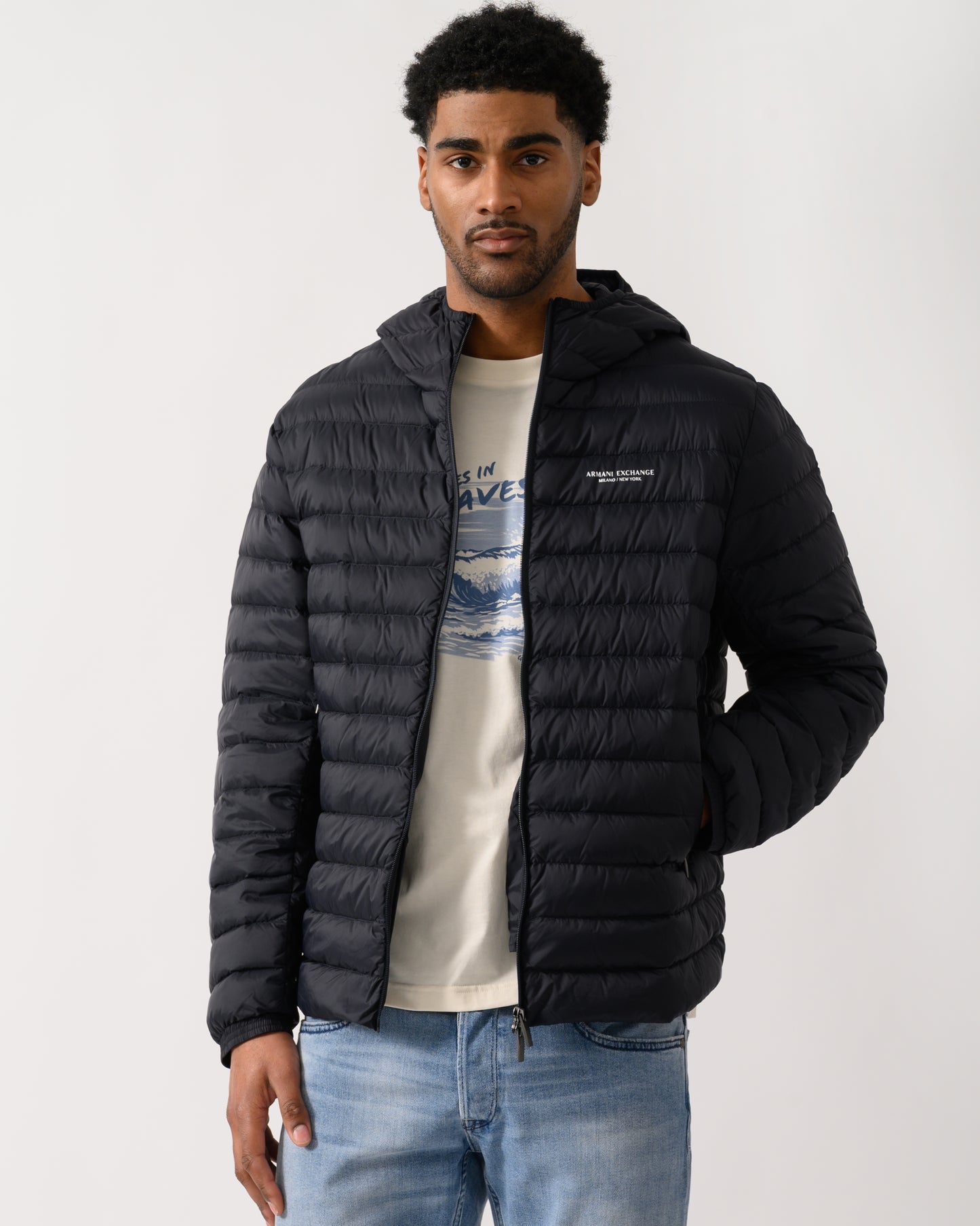 model wearing a Armani Exchange Mens Down Jacket XM001577-AF16927 in Deep Navy UB101