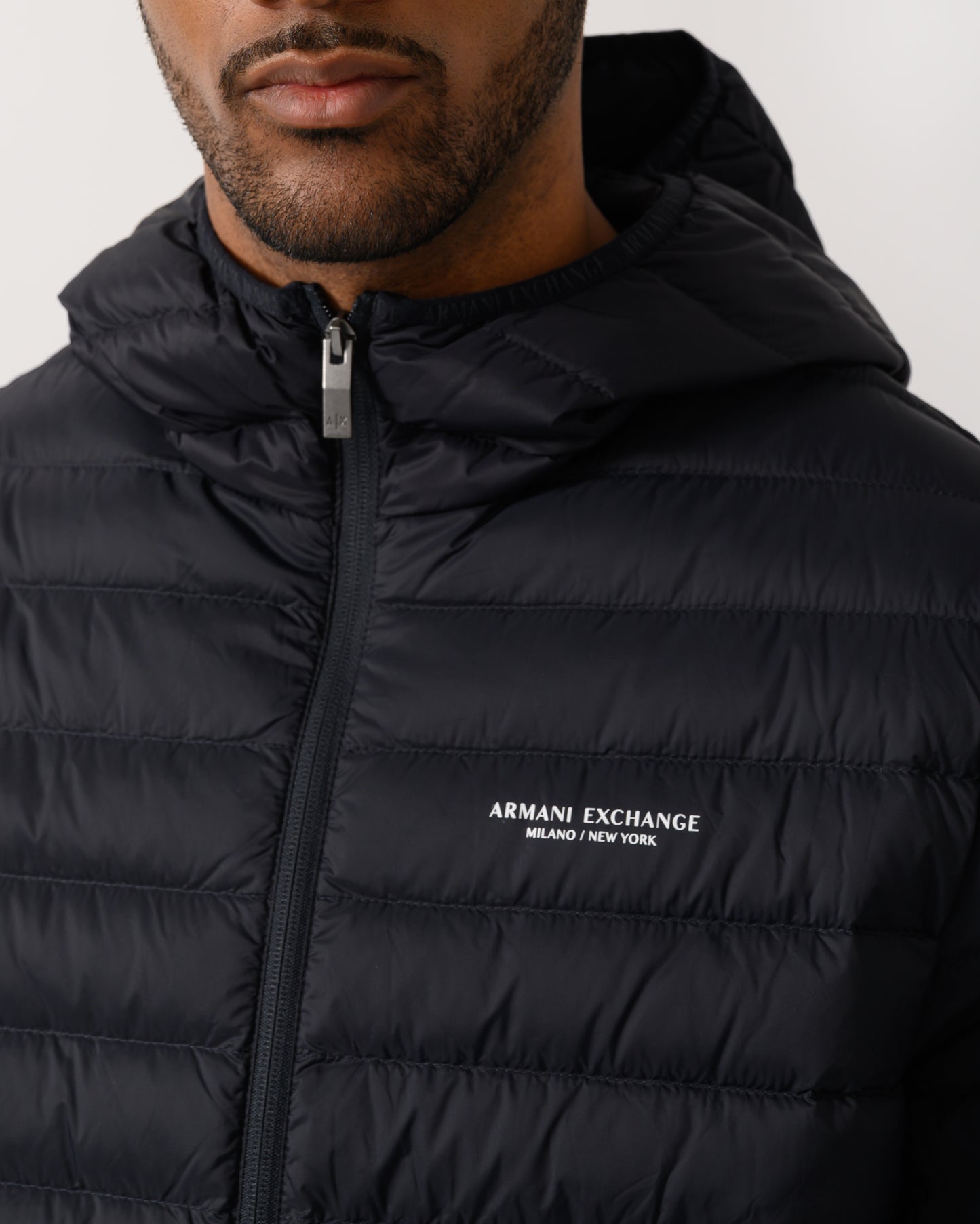 logo detail of a Armani Exchange Mens Down Jacket XM001577-AF16927 in Deep Navy UB101