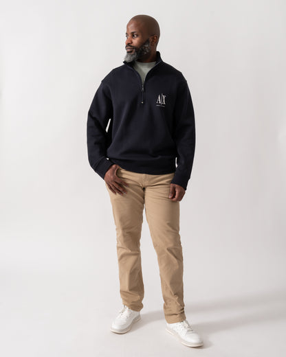 Full length shot of a Model wearing an Armani Exchange Mens Embroidered A|X Logo 1/4 Zip Sweatshirt in Deep Navy