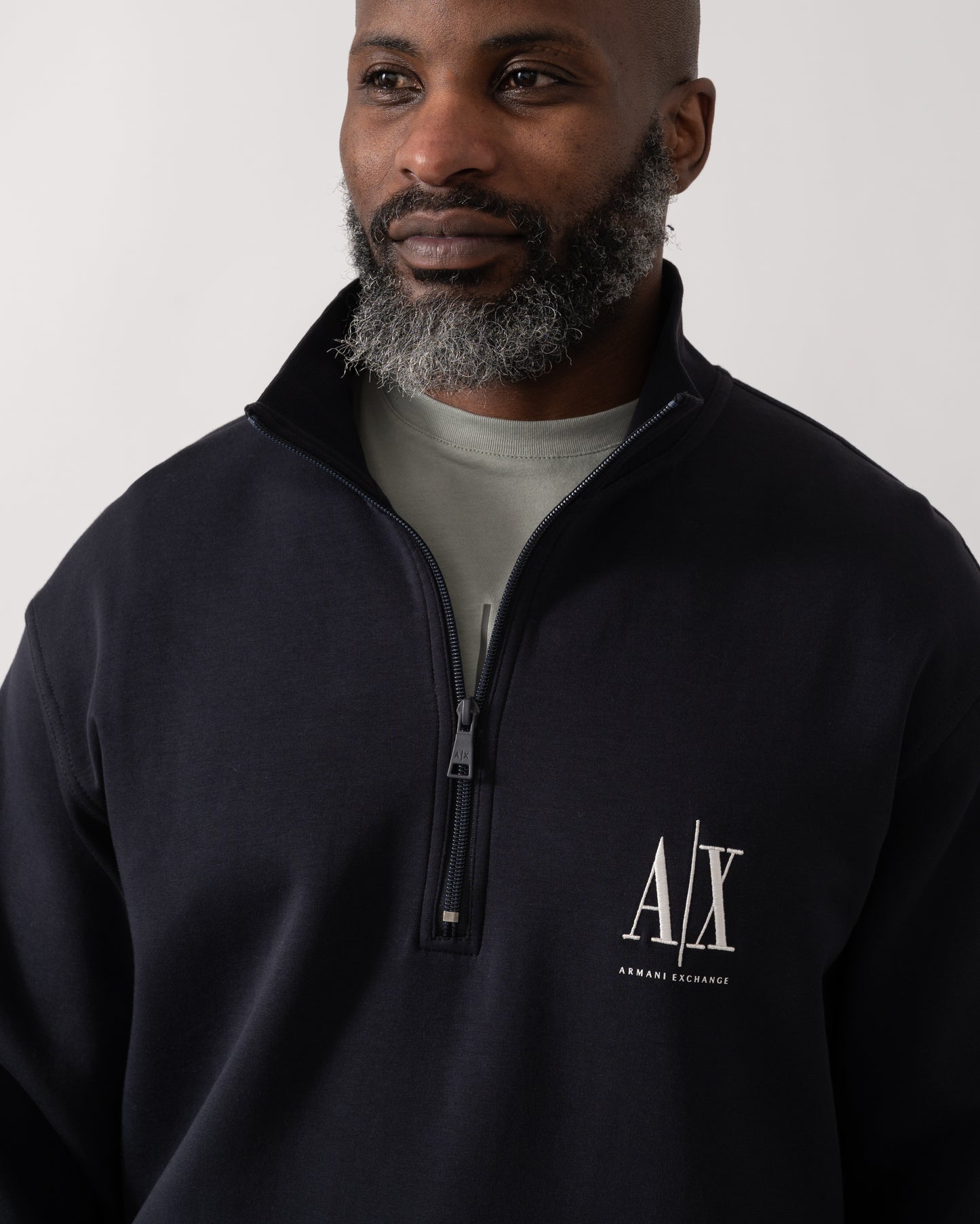 Close up shot of a Model wearing an Armani Exchange Mens Embroidered A|X Logo 1/4 Zip Sweatshirt in Deep Navy