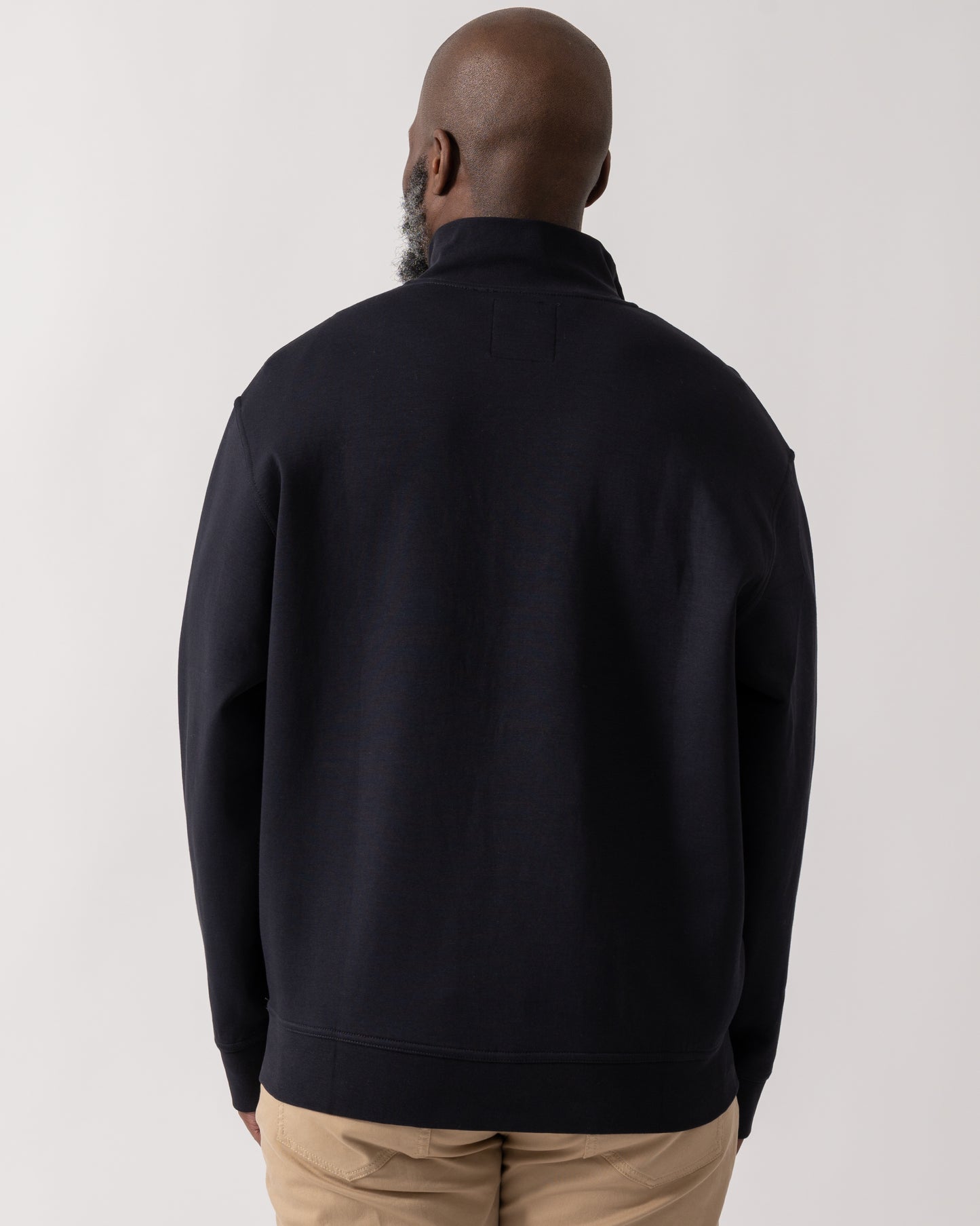 back shot of a Model wearing an Armani Exchange Mens Embroidered A|X Logo 1/4 Zip Sweatshirt in Deep Navy