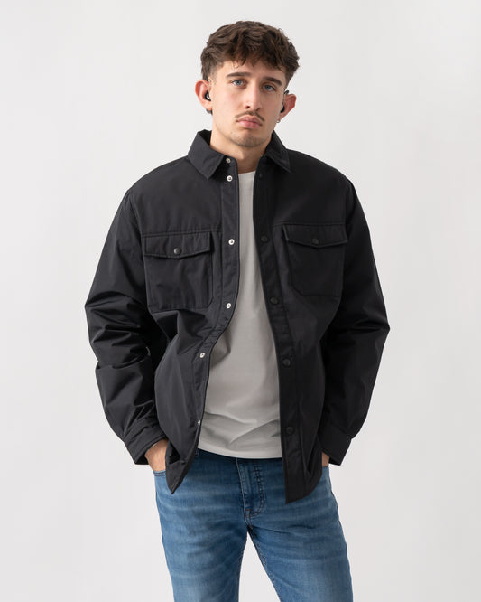 Studio shot of a model wearing an Armani Exchange Mens Padded Overshirt in black