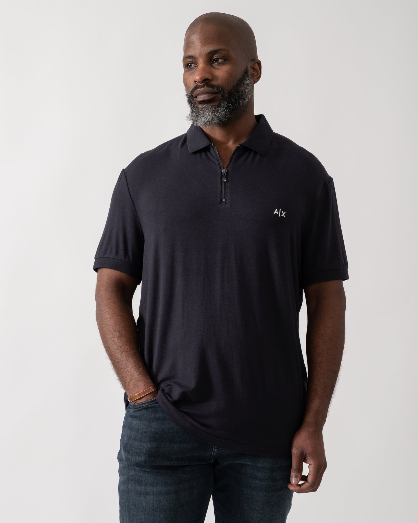 Model wearing an Armani Exchange Mens Polo Shirt in Deep Navy