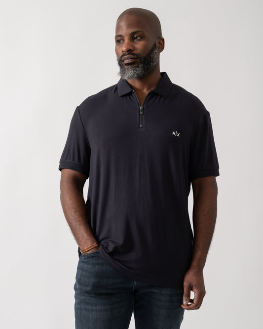 Model wearing an Armani Exchange Mens Polo Shirt in Deep Navy