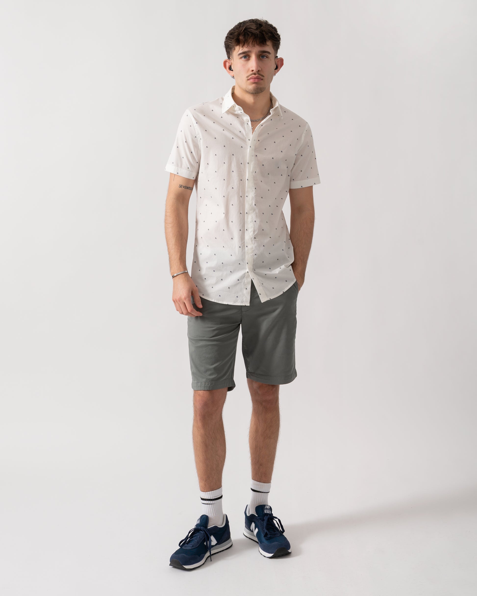 full length shot of a model wearing an Armani Exchange Mens Short Sleeve Shirt with Geometric Pattern in Off White F0198