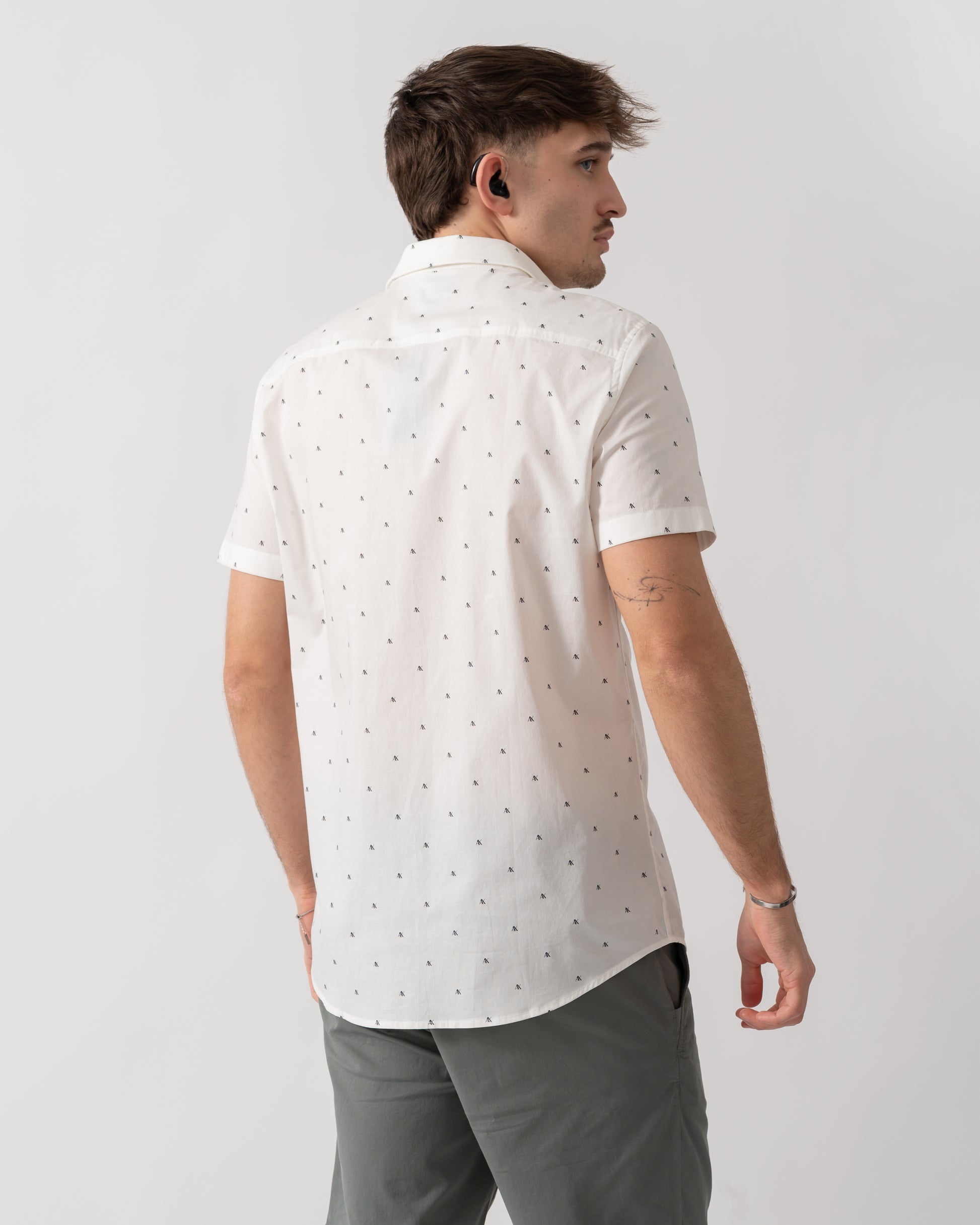 back shot of a model wearing an Armani Exchange Mens Short Sleeve Shirt with Geometric Pattern in Off White F0198