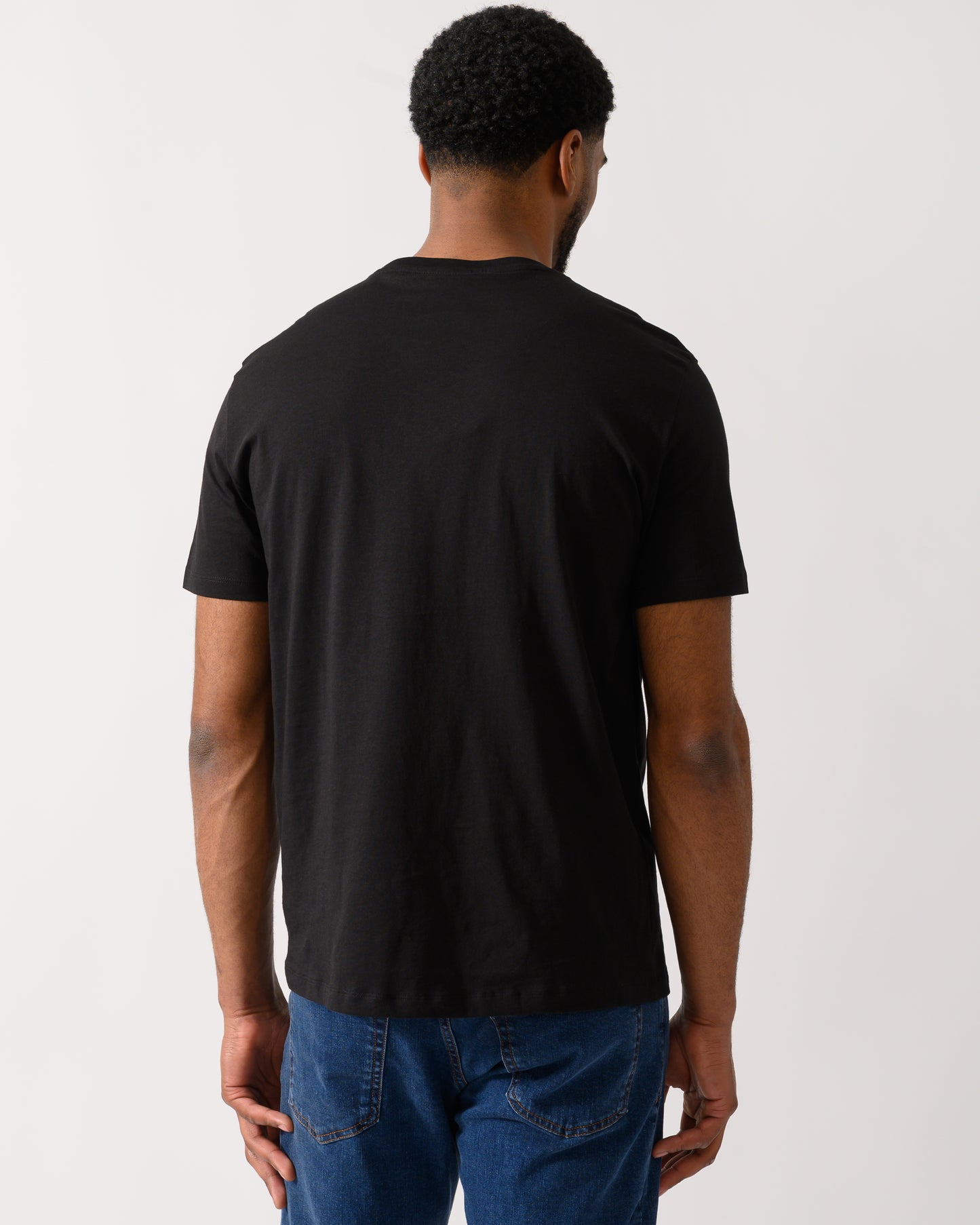 Back shot of a Model wearing a Armani Exchange Mens T-Shirt in Black