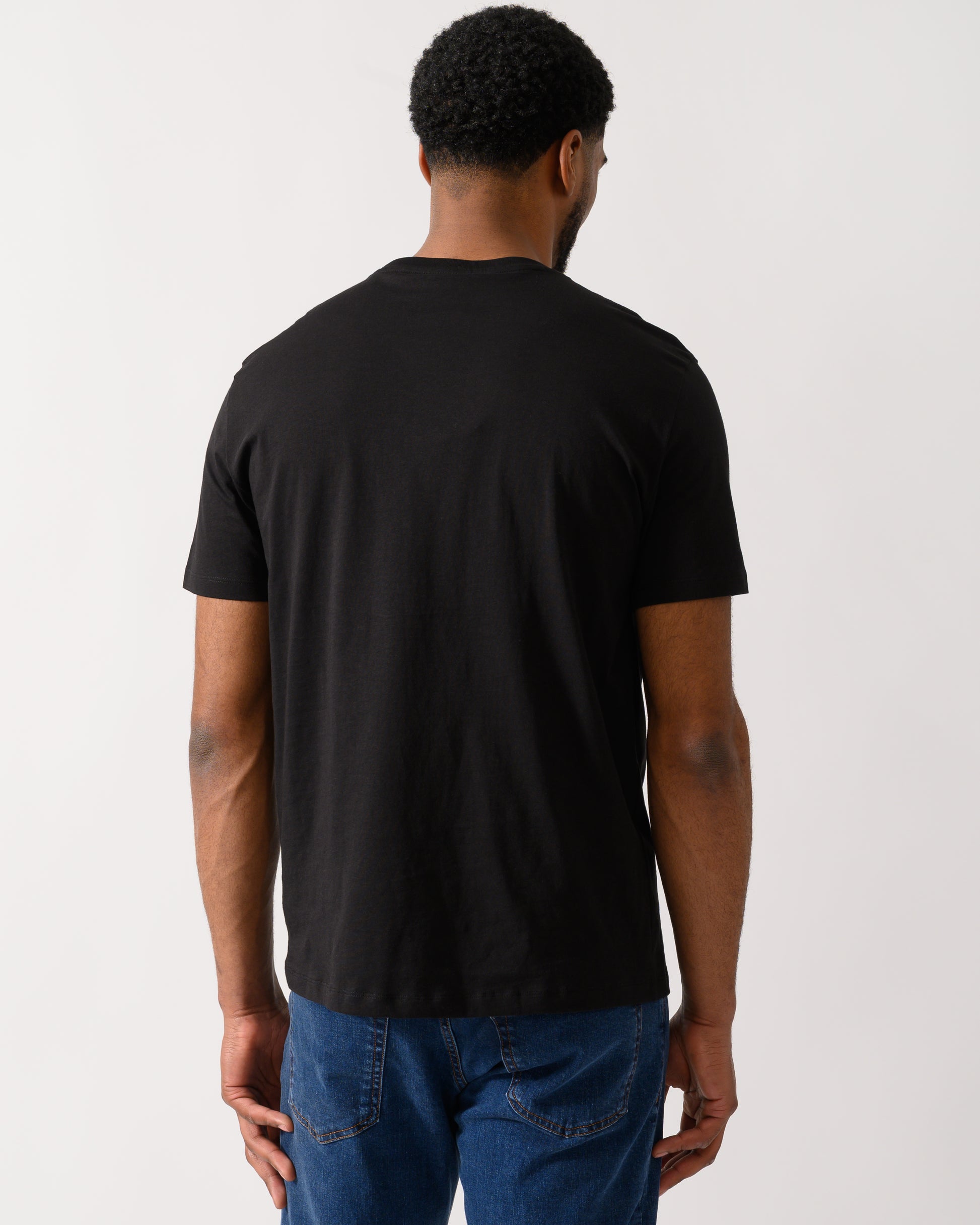 Back shot of a Model wearing a Armani Exchange Mens T-Shirt in Black