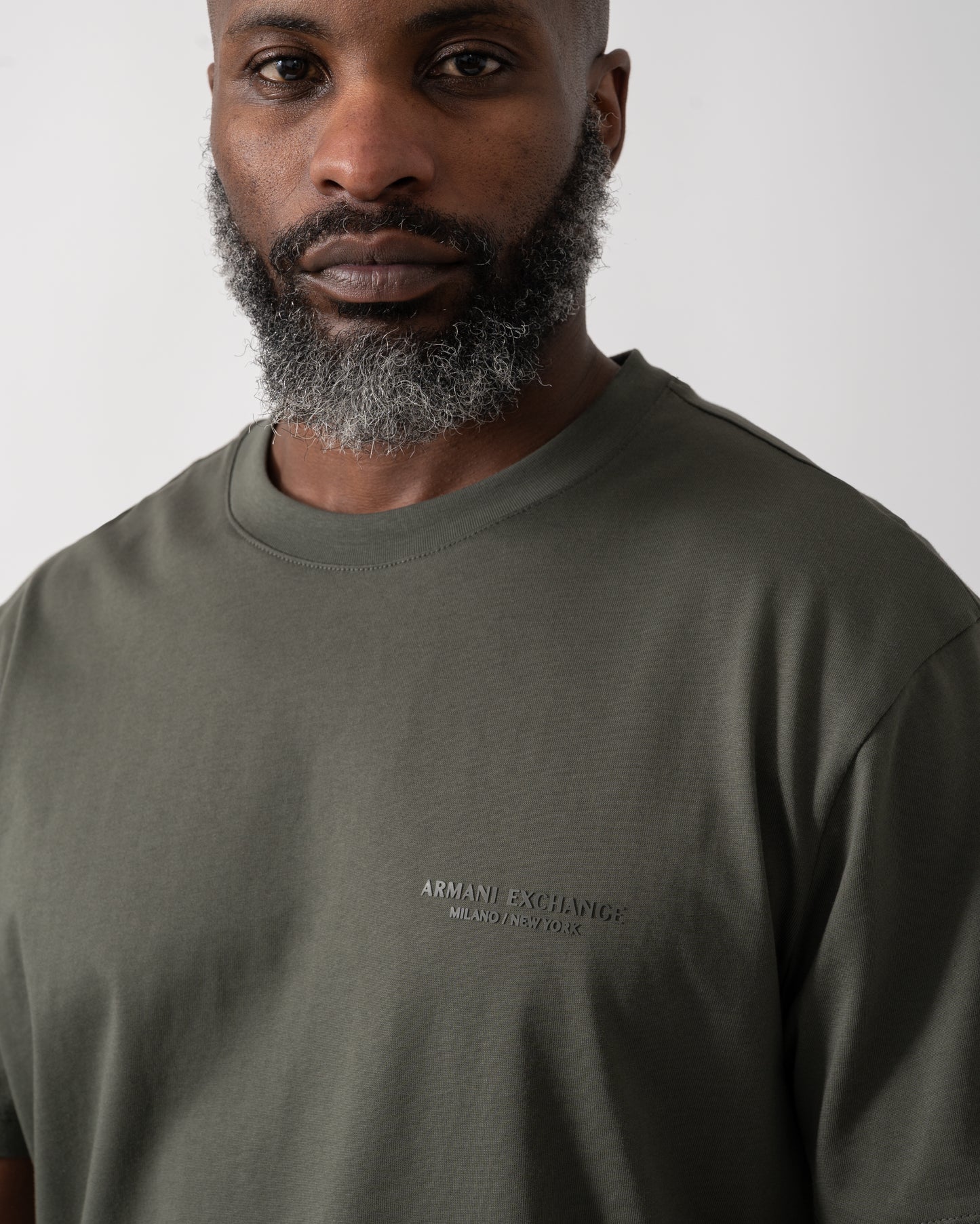 Close up shot of a Model wearing an Armani Exchange Mens T-Shirt with Small Milano/New York Logo in Chimera